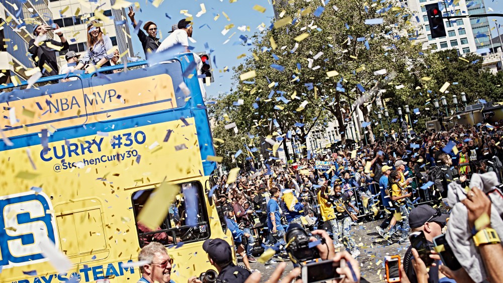 Steph Curry waves to the cheering crowd during the Golden State Warriors' victory parade down Broadway in Oakland, Calif. on June 19, 2015. (Photo by Balazs Gardi for MSNBC)
