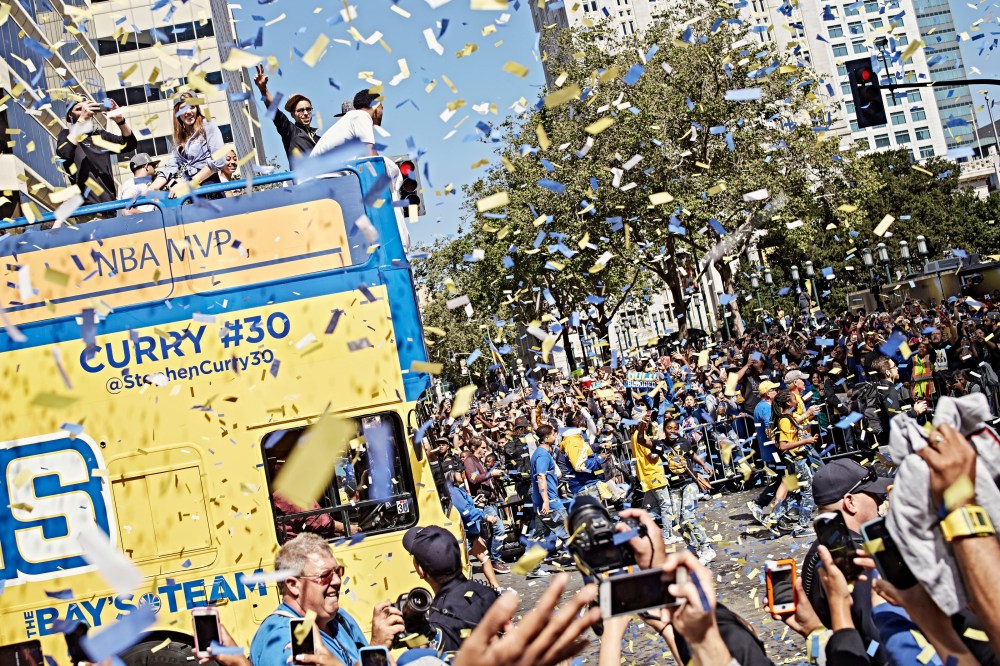 Steph Curry waves to the cheering crowd during the Golden State Warriors' victory parade down Broadway in Oakland, Calif. on June 19, 2015. (Photo by Balazs Gardi for MSNBC)