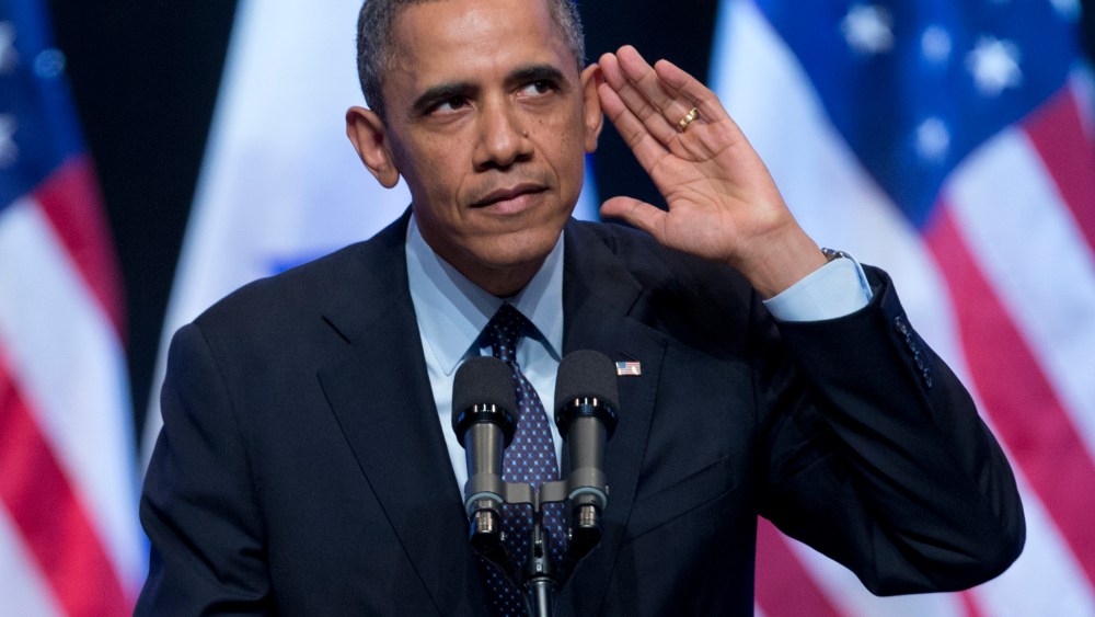 President Barack Obama looks into the crowd and tries to hear a person yelling at him during his speech at the International Convention Center in Jerusalem, Thursday, March 21, 2013. (Photo by Carolyn Kaster/AP)