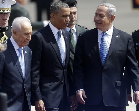 President Barack Obama is greeted by Israeli President Shimon Perez, left, and Israeli Prime Minister Benjamin Netanyahu, right, upon his arrival ceremony at Ben Gurion International Airport in Tel Aviv, Israel, Wednesday, March 20, 2013. (AP Photo...