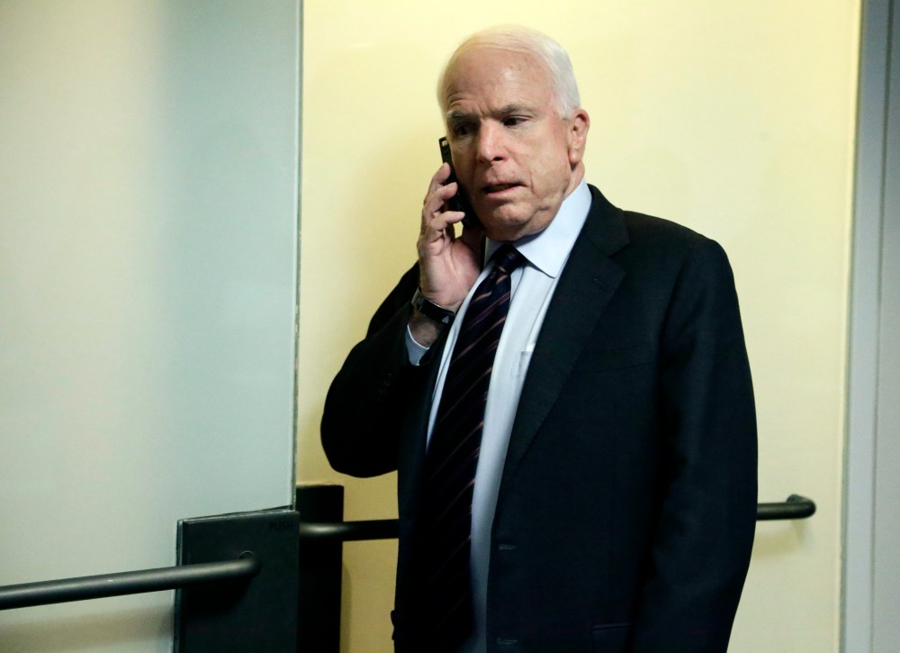Sen. John McCain, R-Ariz., talks on a phone as he returns for a closed-door oversight hearing of the committee on Capitol Hill in Washington, Thursday, Nov. 15, 2012, looking into the circumstances surrounding the deadly attack on the U.S. Consulate in...