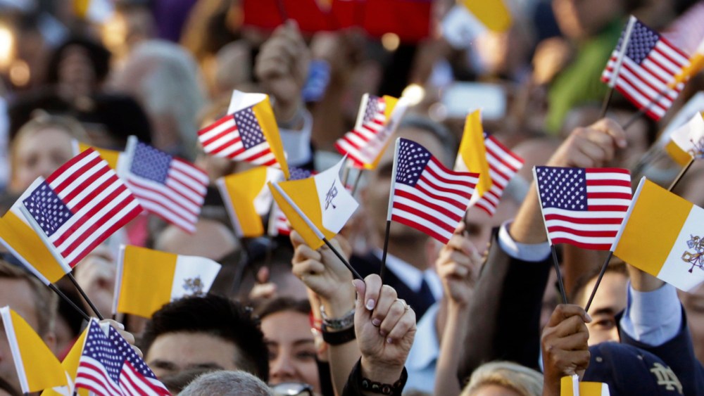 Spectators hoping for a glimpse of Pope Francis waves Papal and U.S. Flags on the South Lawn of the White House in Washington, D.C., Sept. 23, 2015. (Photo by Pablo Martinez Monsivais/AP)