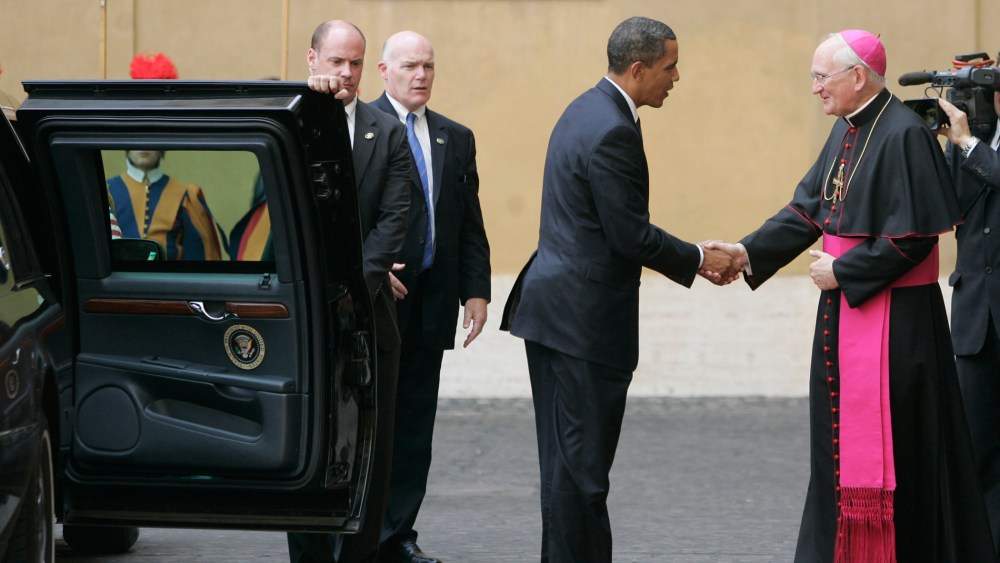 President Barack Obama is welcomed by Bishop James Harvey, at right, as he arrives at the Vatican for a meeting with Pope Benedict XVI, Friday July 10, 2009.