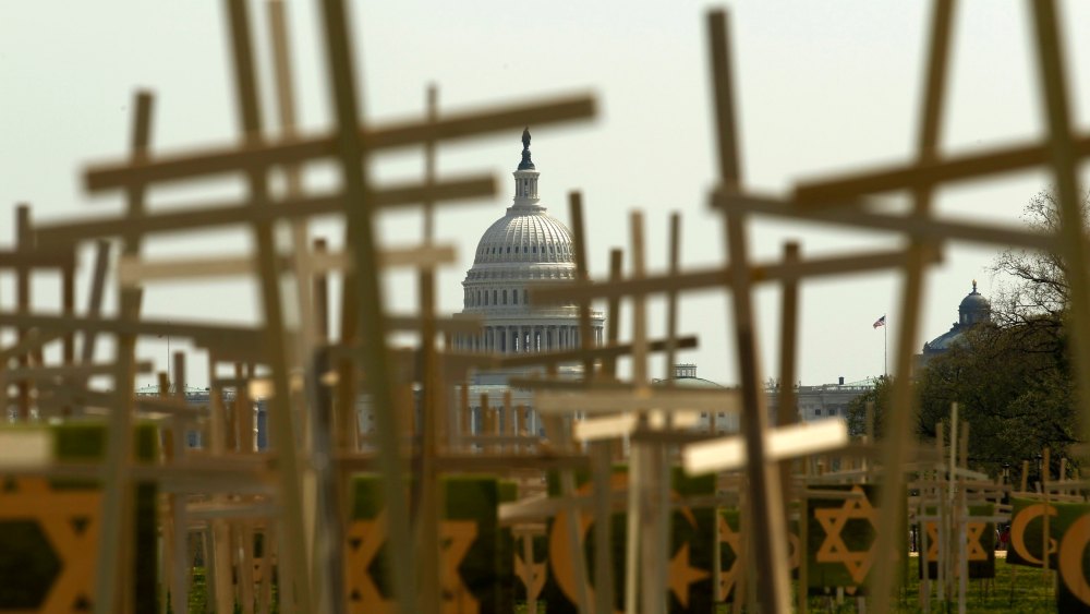 With the U.S. Capitol in the background, crosses symbolizing grave markers are placed upon the National Mall in Washington April 11, 2013. The PICO National Network's Lifelines to Healing and Sojourners are holding a 24-hour vigil featuring a gathering...