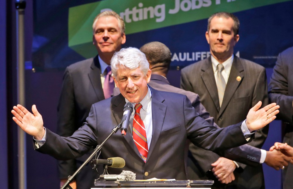 Democratic candidate for Attorney General, State Sen. Mark Herring, center, gesturing as Democratic gubernatorial candidate, Terry McAuliffe, left, and Lt. Governor candidate, State Sen. Ralph Notrham, right, look on during a breakfast appearance in Ric