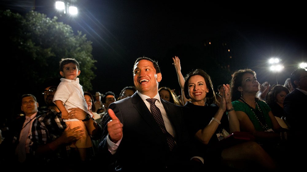 Rep. Trey Martinez Fischer (TX) claps and cheers next to his wife, Elizabeth Provencio, Right (short black hair) at the Mexican American Legislative Caucus's 40th Anniversary, which drew a crowd of thousands with dancing and music by the famous Latino...