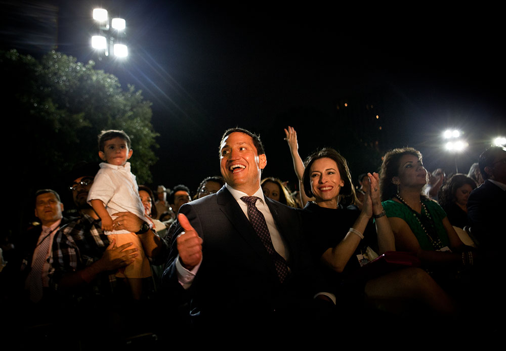 Rep. Trey Martinez Fischer (TX) claps and cheers next to his wife, Elizabeth Provencio, Right (short black hair) at the Mexican American Legislative Caucus's 40th Anniversary, which drew a crowd of thousands with dancing and music by the famous Latino...