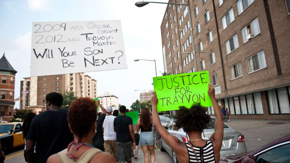 People march in Washington on July 19, 2013 during a demonstration against the acquittal of George Zimmermann in the killing of unarmed Florida teen Trayvon Martin. (Photo by Nicholas Kamm/AFP/Getty)