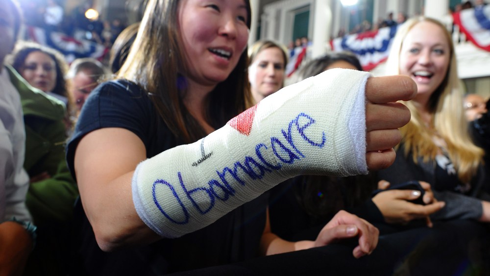 Cathey Park shows her bandaged hand written "I love Obamacare" as she waits to hear US President Barack Obama speaking on healthcare at the Faneuil Hall in Boston, Mass., on Oct. 30, 2013.