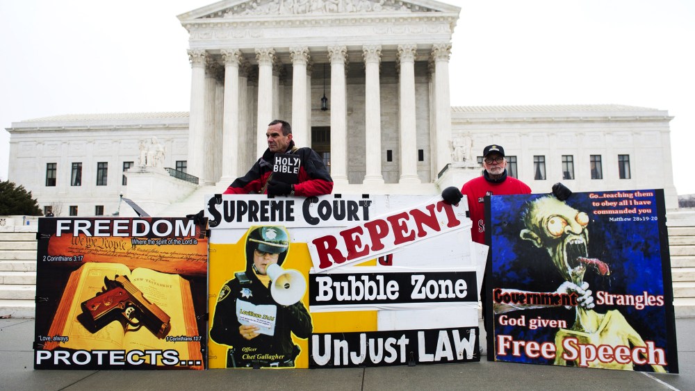 Pro-life demonstrators stand outside the US Supreme Court following oral arguments in the case of McCullen v. Coakley, Jan. 15, 2014.