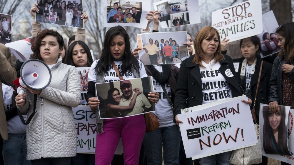 Activists hold signs and family photos in Lafayette Square outside the White House March 12, 2014 in Washington, D.C.