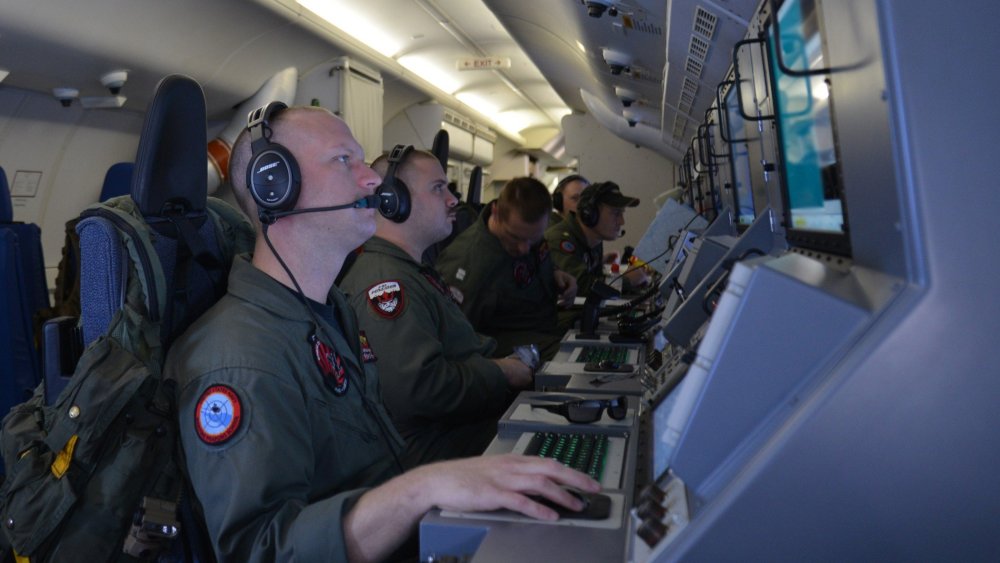 This March 16, 2014 US Navy handout image shows crew members on board a P-8A Poseidon assigned to Patrol Squadron (VP) 16 man their workstations while assisting in search and rescue operations for Malaysia Airlines flight MH370.
