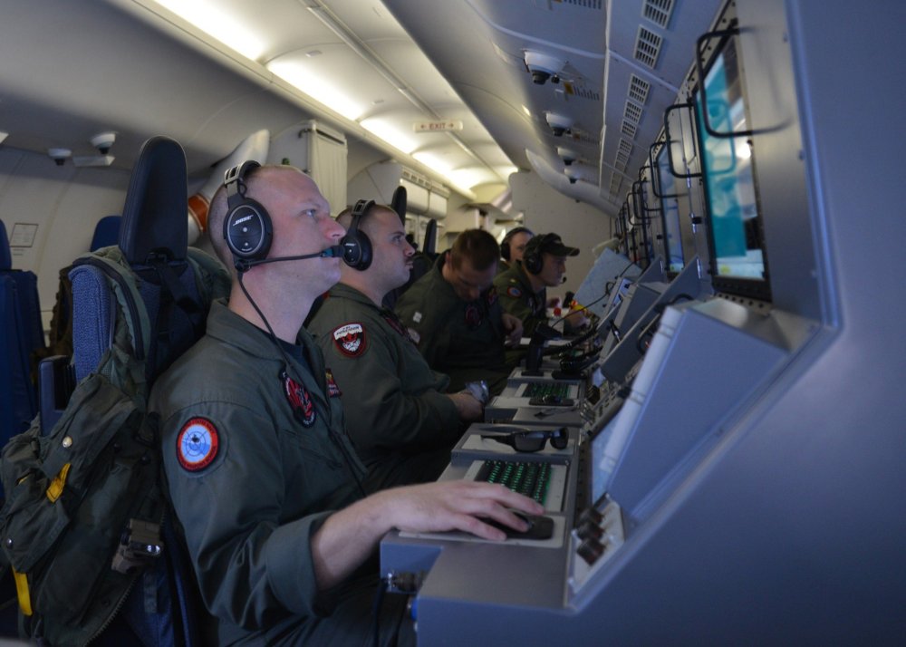This March 16, 2014 US Navy handout image shows crew members on board a P-8A Poseidon assigned to Patrol Squadron (VP) 16 man their workstations while assisting in search and rescue operations for Malaysia Airlines flight MH370.