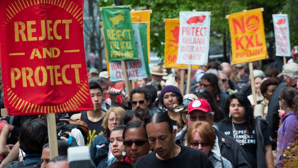 Members of the The Cowboy and Indian Alliance protest across the street from US Secretary of State John Kerry's house, April 25, 2014.
