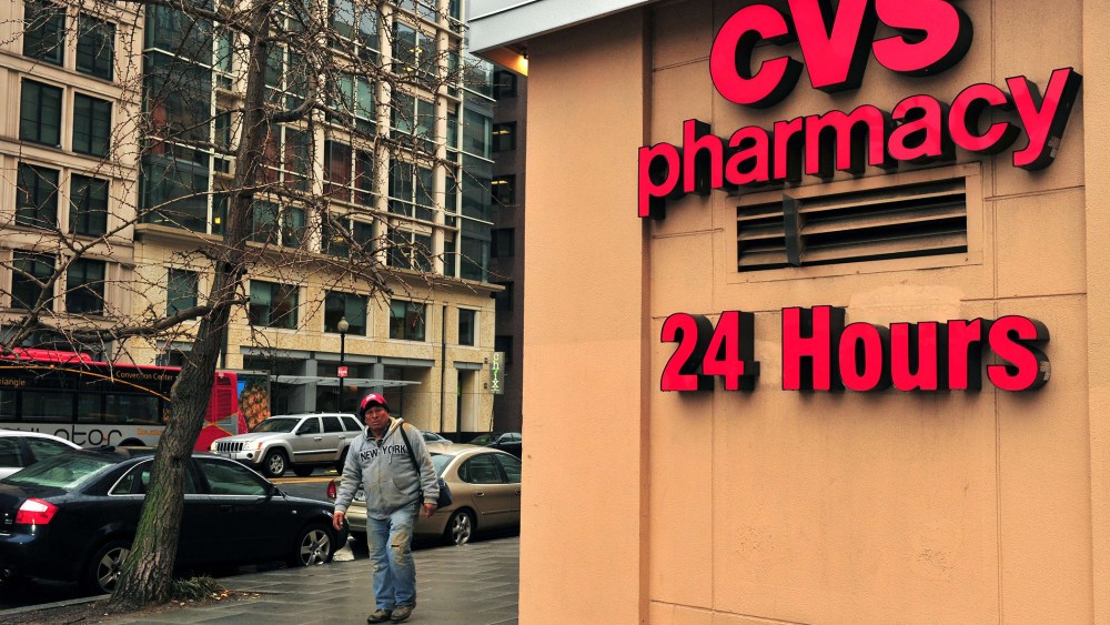 A man passes a CVS drugstore in Washington, DC., February 5, 2014.