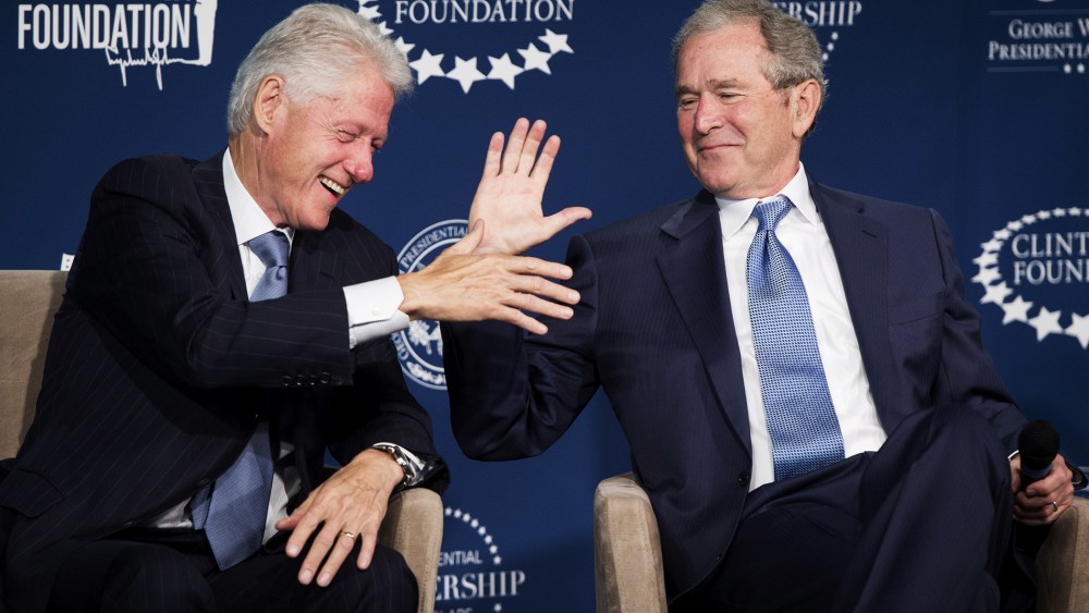 Bill Clinton and George W. Bush shake hands during the launch of the Presidential Leadership Scholars Program in Washington, DC, September 8, 2014.
