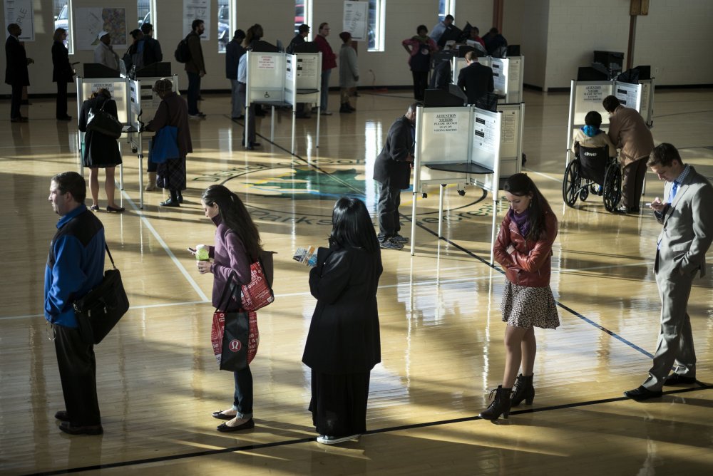 Voters cast their ballots while others wait their turn at the Kennedy Recreation Center on Nov. 4, 2014 in Washington, DC.