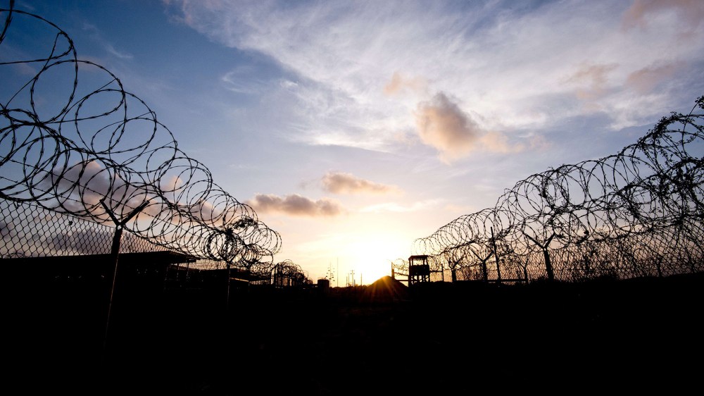 This April 9, 2014 file photo made during an escorted visit and reviewed by the US military, shows the razor wire-topped fence and a watch tower at the abandoned "Camp X-Ray" in Guantanamo Bay, Cuba. (Photo by Mladen Antonov/AFP/Getty)