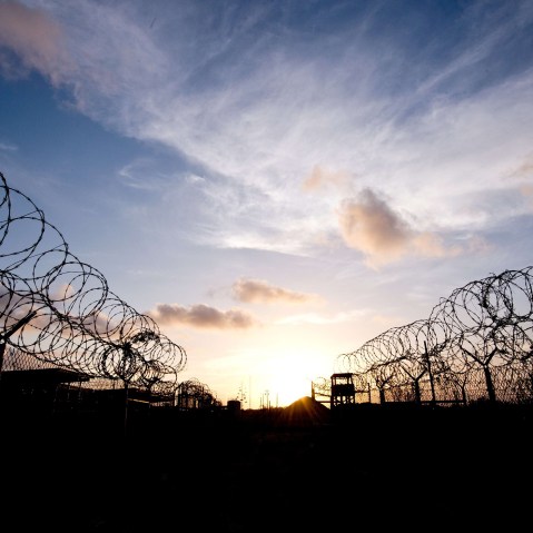 This April 9, 2014 file photo made during an escorted visit and reviewed by the US military, shows the razor wire-topped fence and a watch tower at the abandoned "Camp X-Ray" detention facility at the US Naval Station in Guantanamo Bay, Cuba.