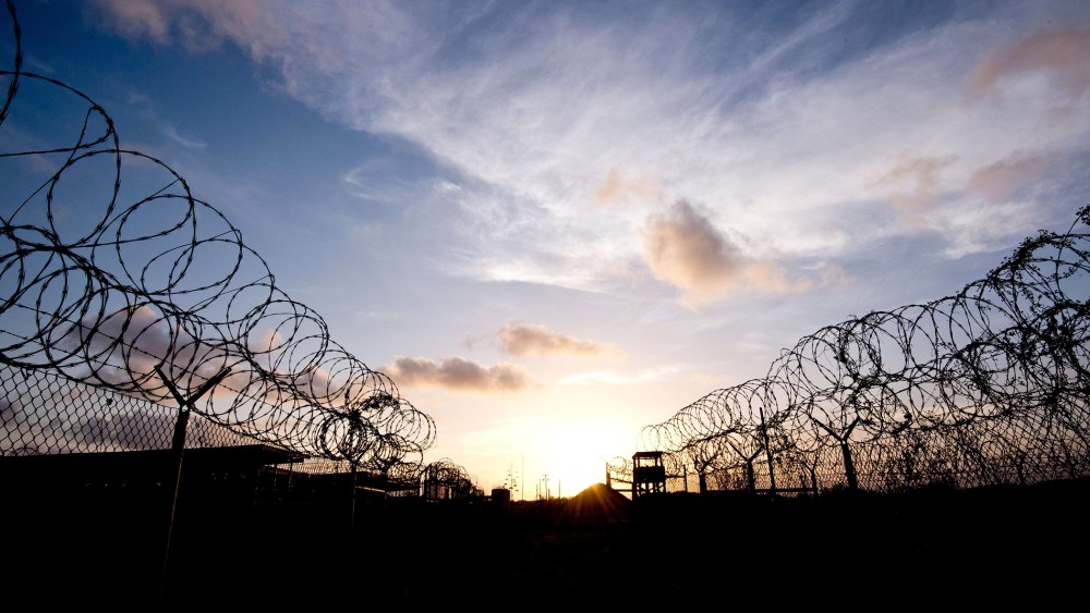 This April 9, 2014 file photo made during an escorted visit and reviewed by the US military, shows the razor wire-topped fence and a watch tower at the abandoned "Camp X-Ray" detention facility at the US Naval Station in Guantanamo Bay, Cuba.