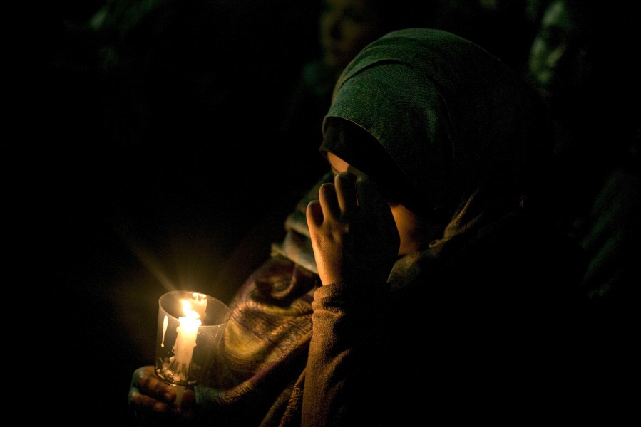 A woman holds a candle during a vigil at the University of North Carolina following the murders of three Muslim students on Feb. 11, 2015 in Chapel Hill, N.C.