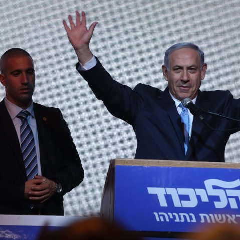 Israeli Prime Minister Benjamin Netanyahu (C) delivers a speech next to his wife Sara as he reacts to exit poll figures in Israel's parliamentary elections late on March 17, 2015 in the city of Tel Aviv. (Photo by Menahem Kahana/AFP/Getty)