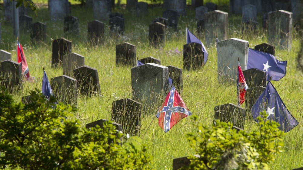 Confederate flags stand next to the headstone's of Confederate States of America (CSA) soldiers at the Magnolia Cemetery in Charleston, S.C., June 26, 2015. (Photo by Jim Watson/AFP/Getty)