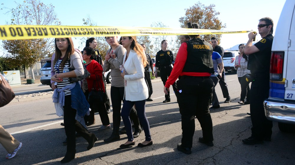 Survivors are evacuated from the scene of a shooting under police and sheriff's escort on Dec. 2, 2015 in San Bernardino, Calif. (Photo by Frederic J. Brown/AFP/Getty)