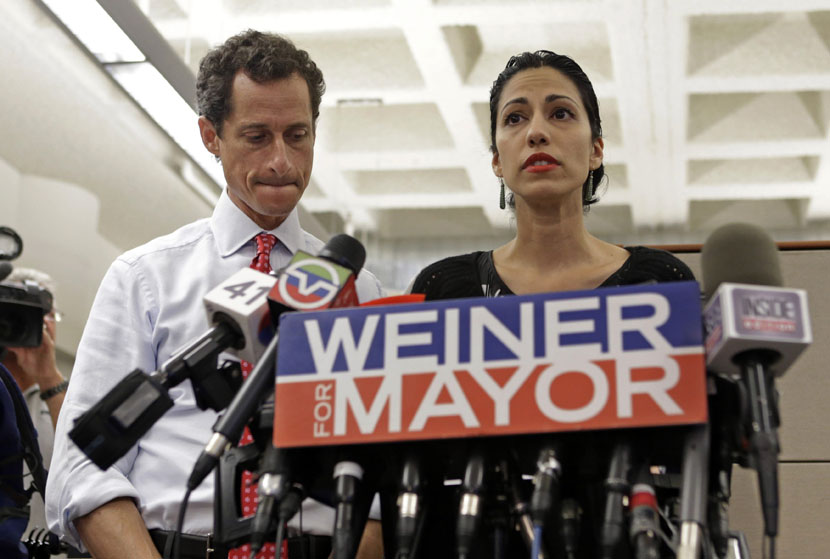 New York mayoral candidate Anthony Weiner, left, listens as his wife, Huma Abedin, speaks during a news conference at the Gay Men's Health Crisis headquarters, Tuesday, July 23, 2013, in New York. (Photo by Kathy Willens/AP)