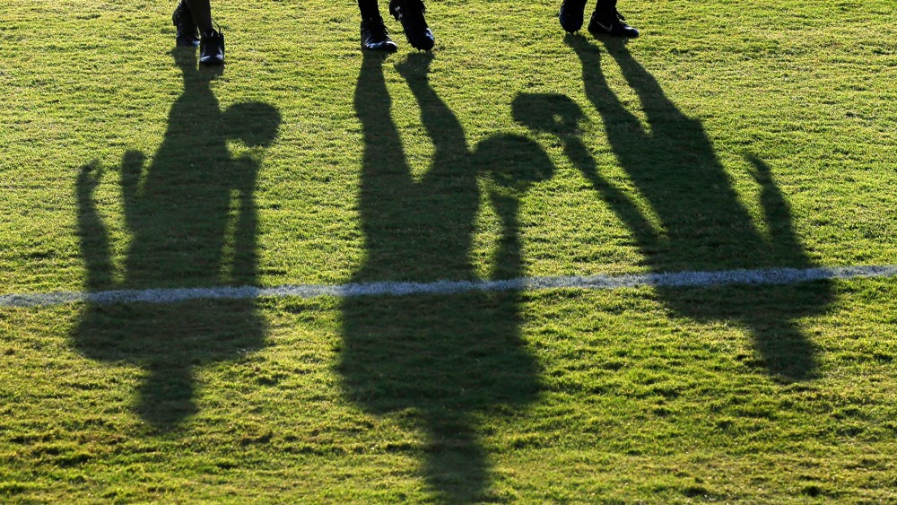 Baltimore Ravens wide receivers cast shadows as they walk off the field after NFL football training camp, Aug. 8, 2015, in Owings Mills, Md.