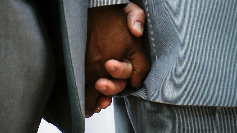 Hank Hamilton and his partner Larry Clement (L) hold hands during their same-sex marriage ceremony in a mass ceremony at Unity in Chicago in Chicago, Illinois, June 1, 2014. Same-sex marriage became legal in the State of Illinois on June 1.