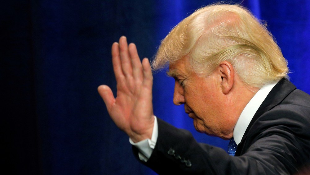 U.S. Republican presidential candidate Donald Trump waves as he walks offstage after delivering a campaign speech about national security in Manchester