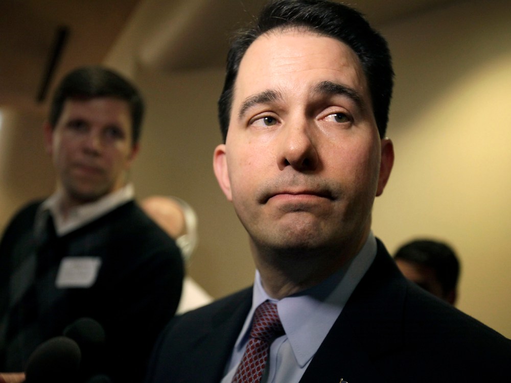 Wisconsin Gov. Scott Walker listens to a question while speaking with media about his proposed reforms to Medicaid, unemployment compensation, and food stamps, at Business Day in Madison. (AP Photo/Wisconsin State Journal, M.P. King)