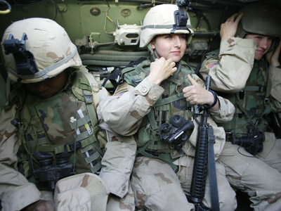 Female soldiers from the U.S. 1st Cavalry join a patrol in Baghdad's al-Jihad quarter in 2004. (File photo by Karim Sahib/AFP/Getty Images)