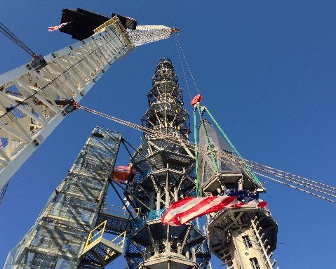 Workers prepare to raise the silver spire atop the 1 World Trade Center building in New York early Friday, May 10, 2013. (AP Photo/Mark Lennihan)