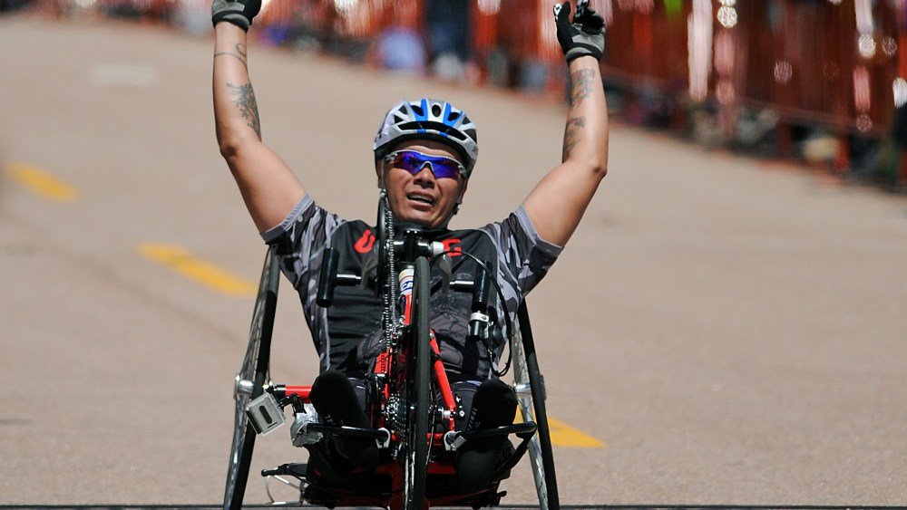 May 12, 2013: Marine Corps wounded warrior, Ronnie Jimenez, celebrates his handcycling victory during the first day of Warrior Games competition at the United States Air Force Academy, Colorado Springs, Colorado. Over 260 injured and disabled service...