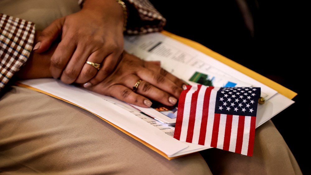 A new citizen holds an American flag during a naturalization ceremony