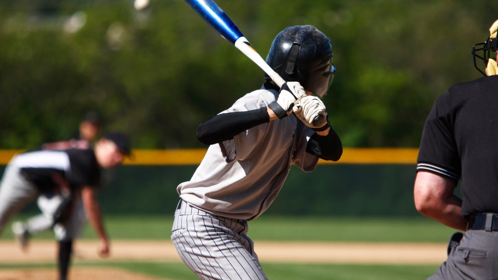 View of baseball batter from behind the catcher as they hit