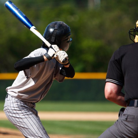 View of baseball batter from behind the catcher as they hit