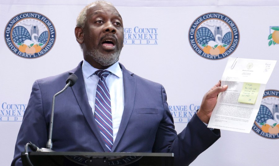 Jerry Demings holds up a copy of the letter