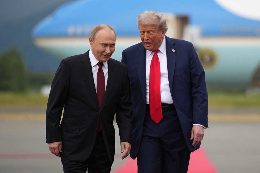President Donald Trump walks with Russian President Vladimir Putin at Joint Base Elmendorf-Richardson in Anchorage, Alaska.