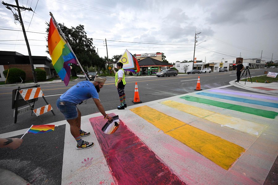 Activists rally at the Pulse Interim Memorial after repainting a rainbow-colored crosswalk on Friday, Aug. 22, 2025, in Orlando, Fla. 