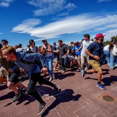 People run after a shot was fired at U.S. right-wing activist and commentator Charlie Kirk at a Utah Valley University speaking event in Orem
