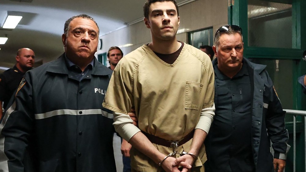 Luigi Mangione, accused of the murder of United Healthcare CEO Brian Thompson, is escorted by police as he arrives at court in New York City on September 16, 2025.