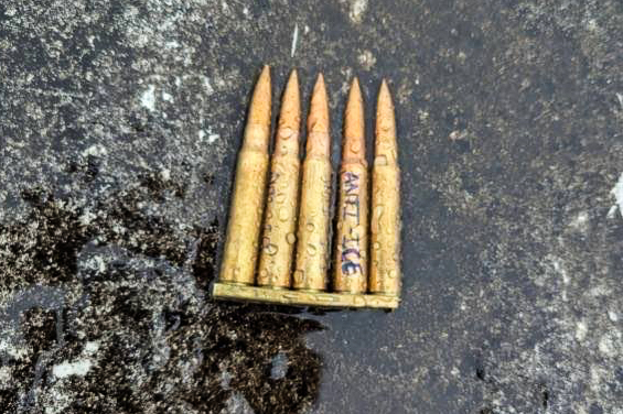 Bullets on the ground with "Anti-ICE" written on one.