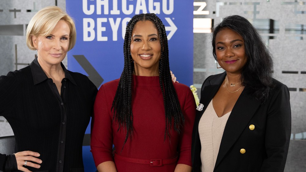 Mika Brzezinski, Liz Dozier, and Tatyana Ali in front of a Chicago Beyond sign.