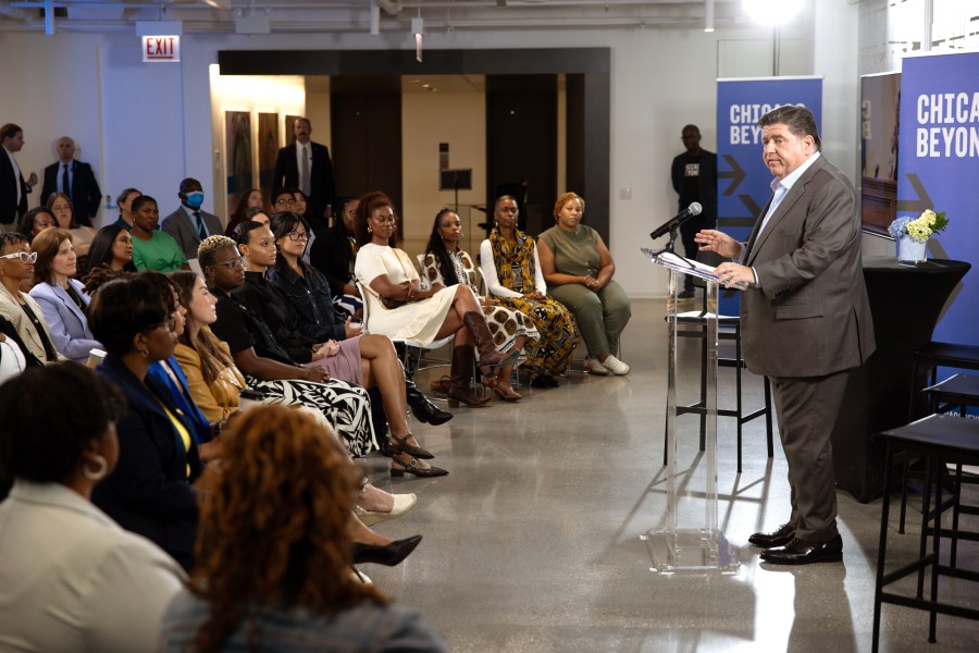 Gov. Pritzker at a podium speaking to the audience at Chicago Beyond.