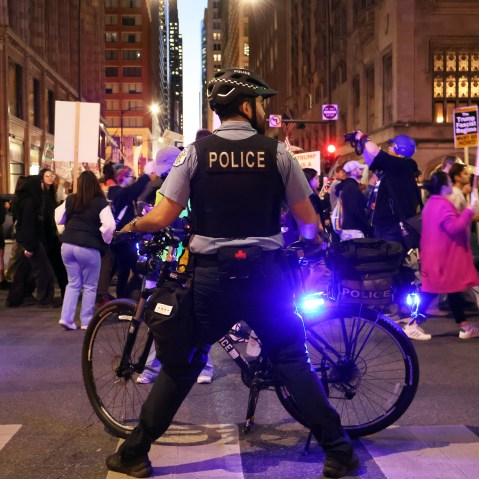 Police patrolling Anti-ICE protesters.