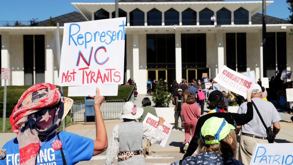 Demonstrators approach the Legislative Building during a rally protesting a proposed election redistricting map on Tuesday.