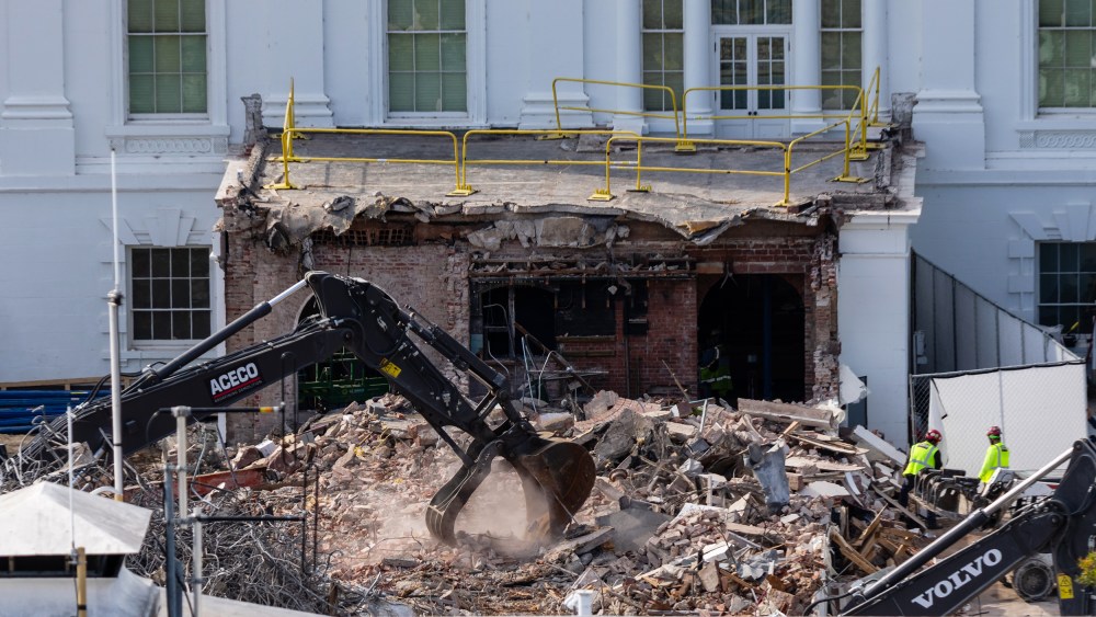 An excavator works to clear rubble after the East Wing of the White House was demolished.